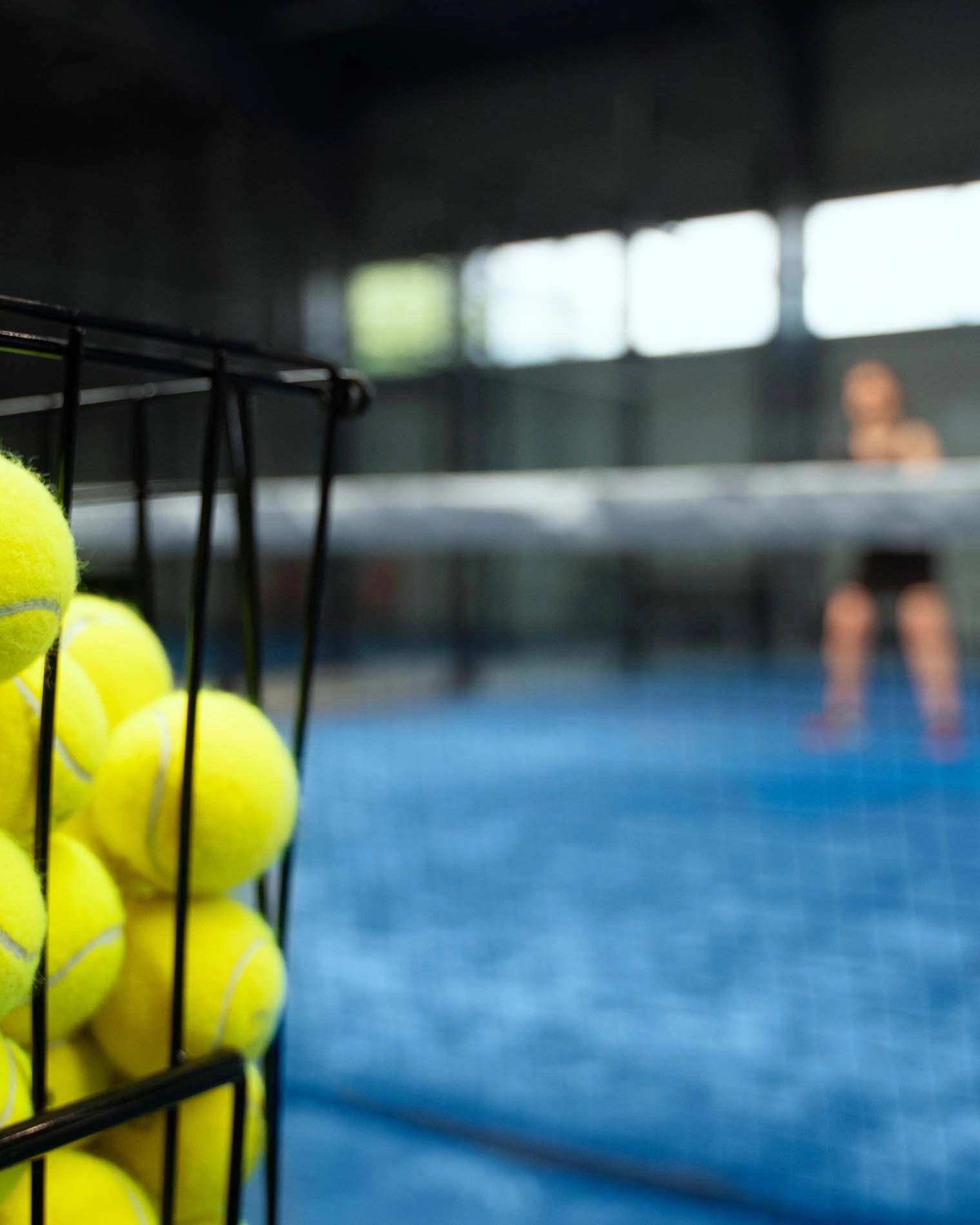 Mann schlägt Vorhand mit Padelschläger während eines Matches